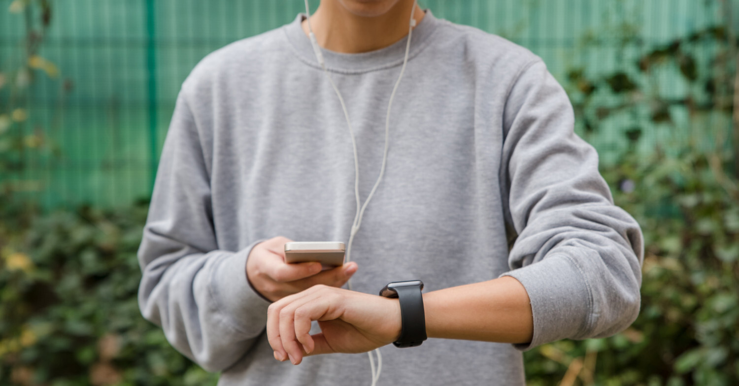 wearable health tech iphone and watch on wrist